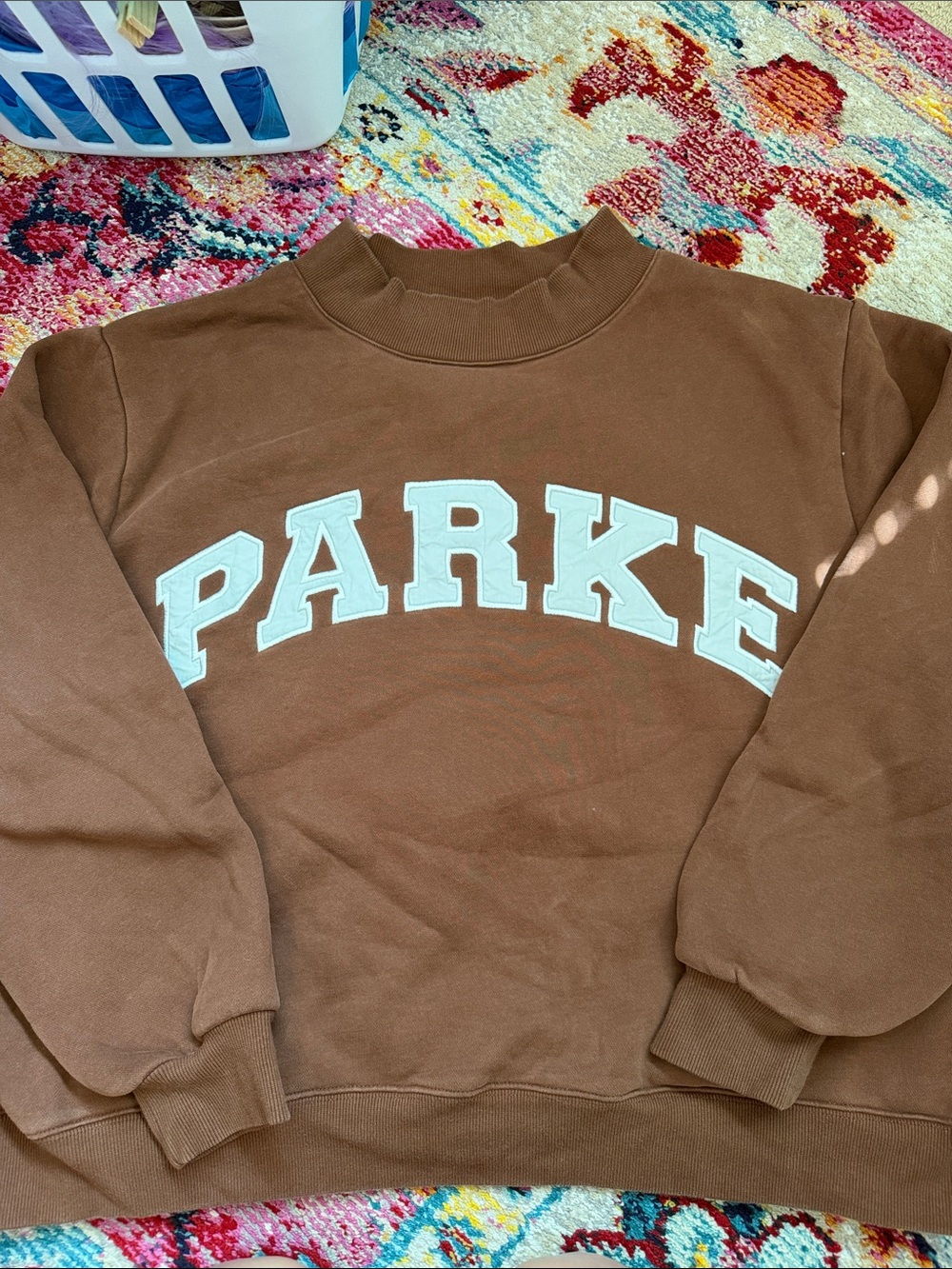 Brown PARKE sweatshirt with very pale blue lettering